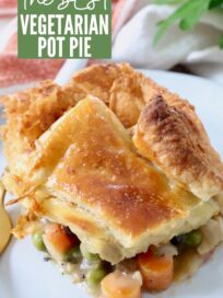 piece of vegetable pot pie on white plate with fork