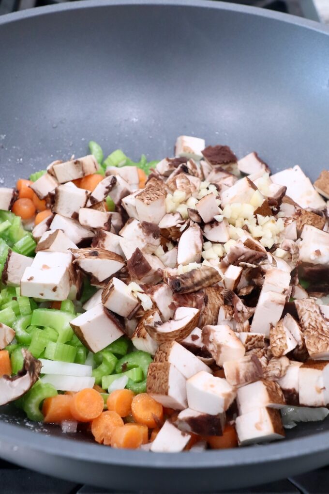diced mushrooms in pan with onions, carrots and celery