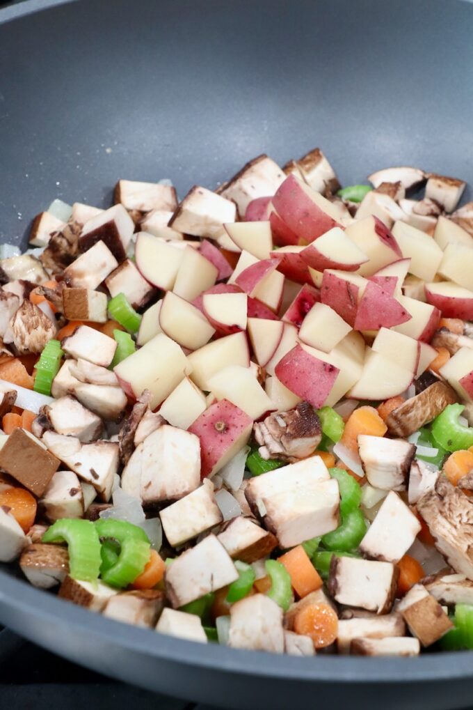 diced potatoes in pan with other diced vegetables