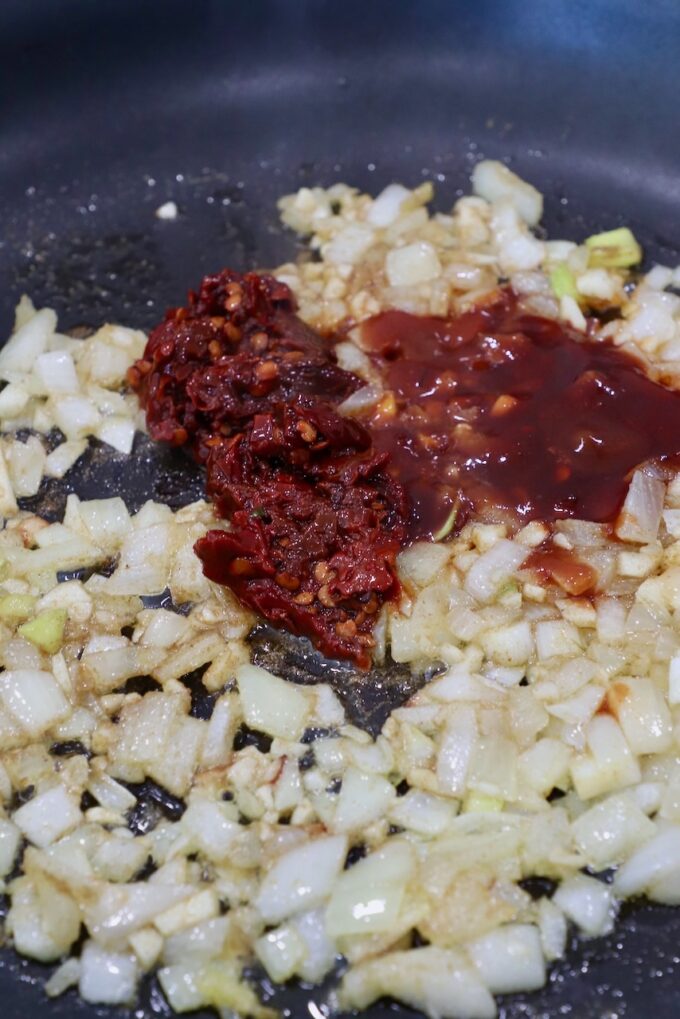 chipotle chilies in skillet with diced onions