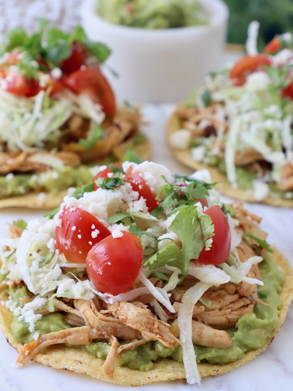 chicken tostadas topped with diced tomatoes