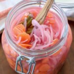 pickled onions, carrots and jalapenos in large glass mason jar