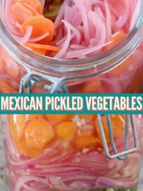 pickled sliced carrots, onions and jalapenos in large glass jar