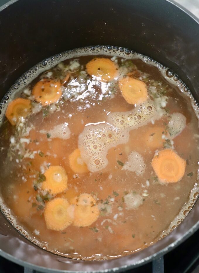 sliced carrots in liquid in pot on the stove