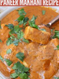 prepared Indian butter paneer in white bowl with copper spoon