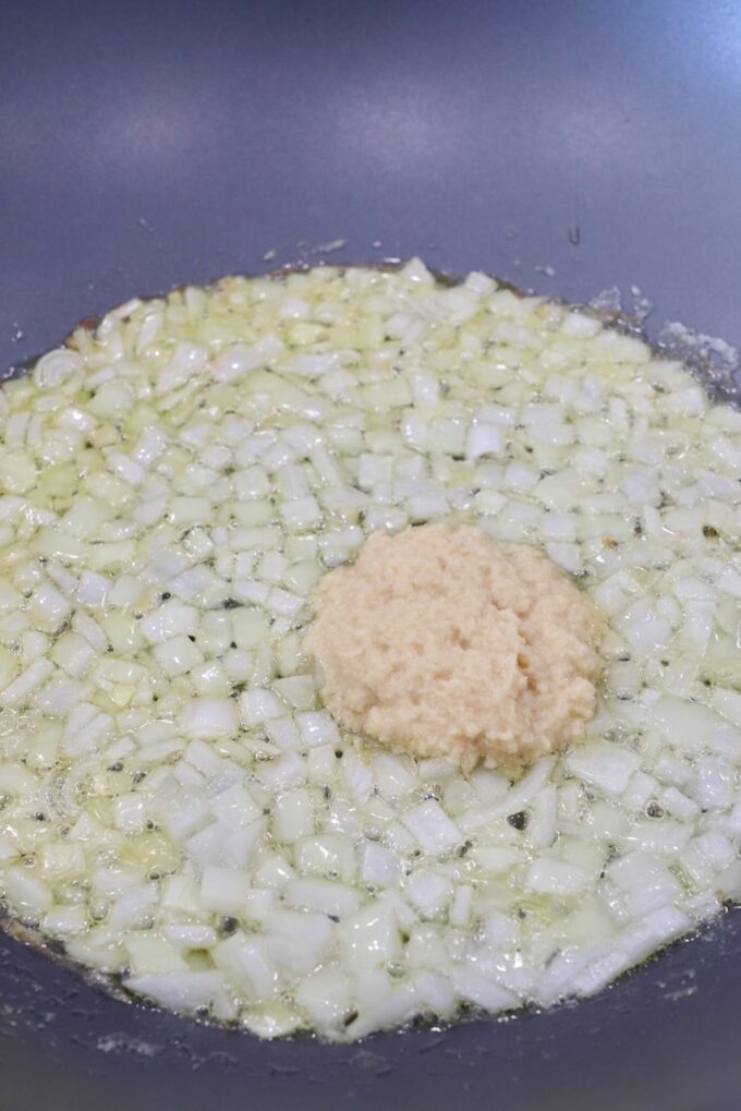 diced onions in large skillet with garlic ginger paste