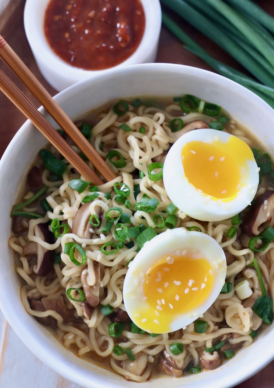 prepared ramen noodle soup in bowl with soft boiled egg and chopsticks
