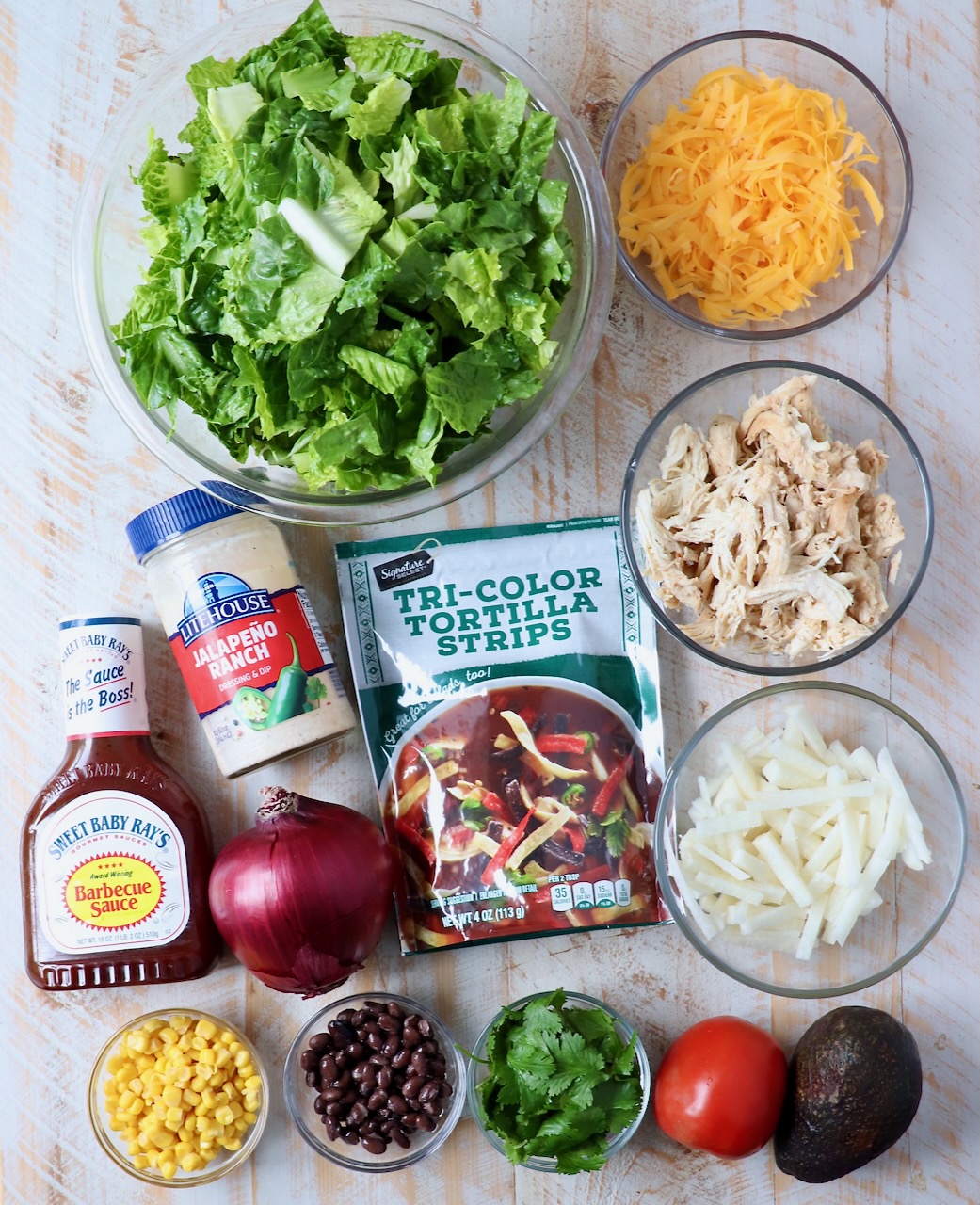 ingredients for bbq chicken salad on white wood board
