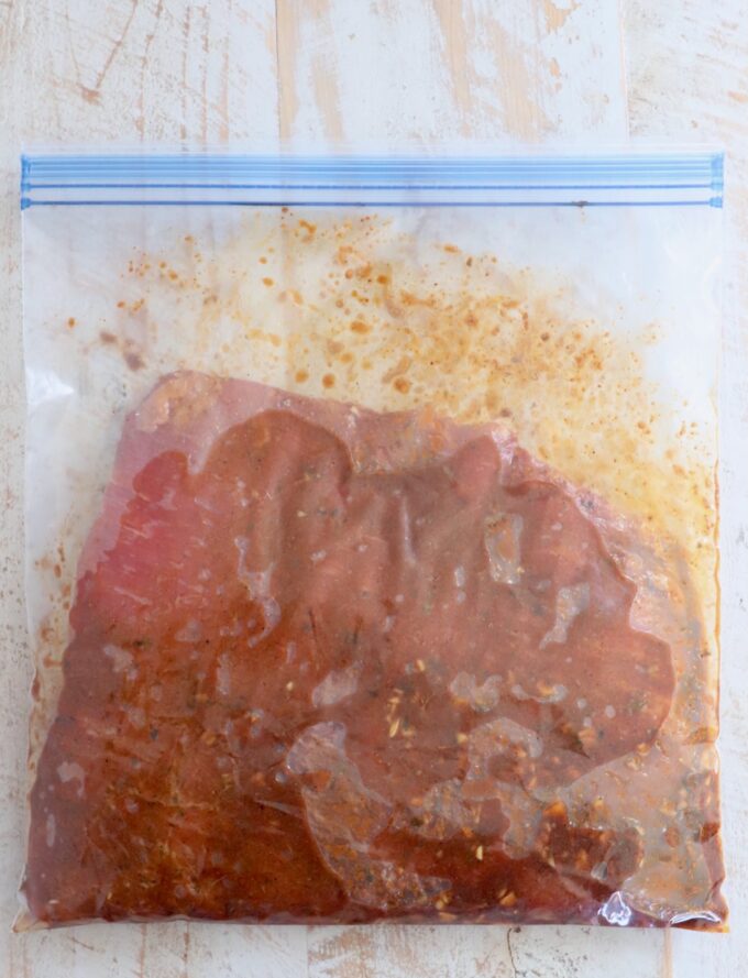 flank steak in marinade in large zipper bag