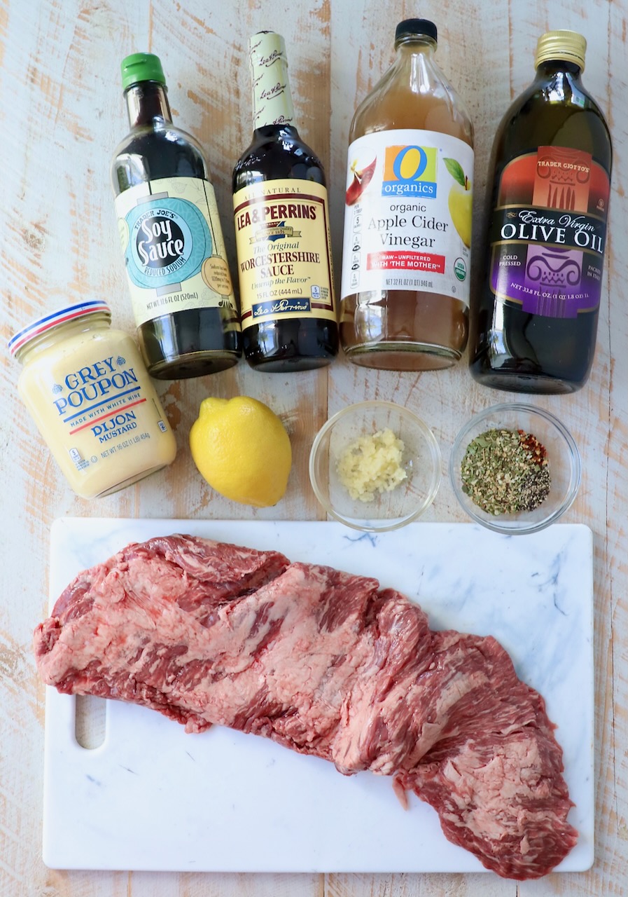 ingredients for marinated skirt steak on white wood board