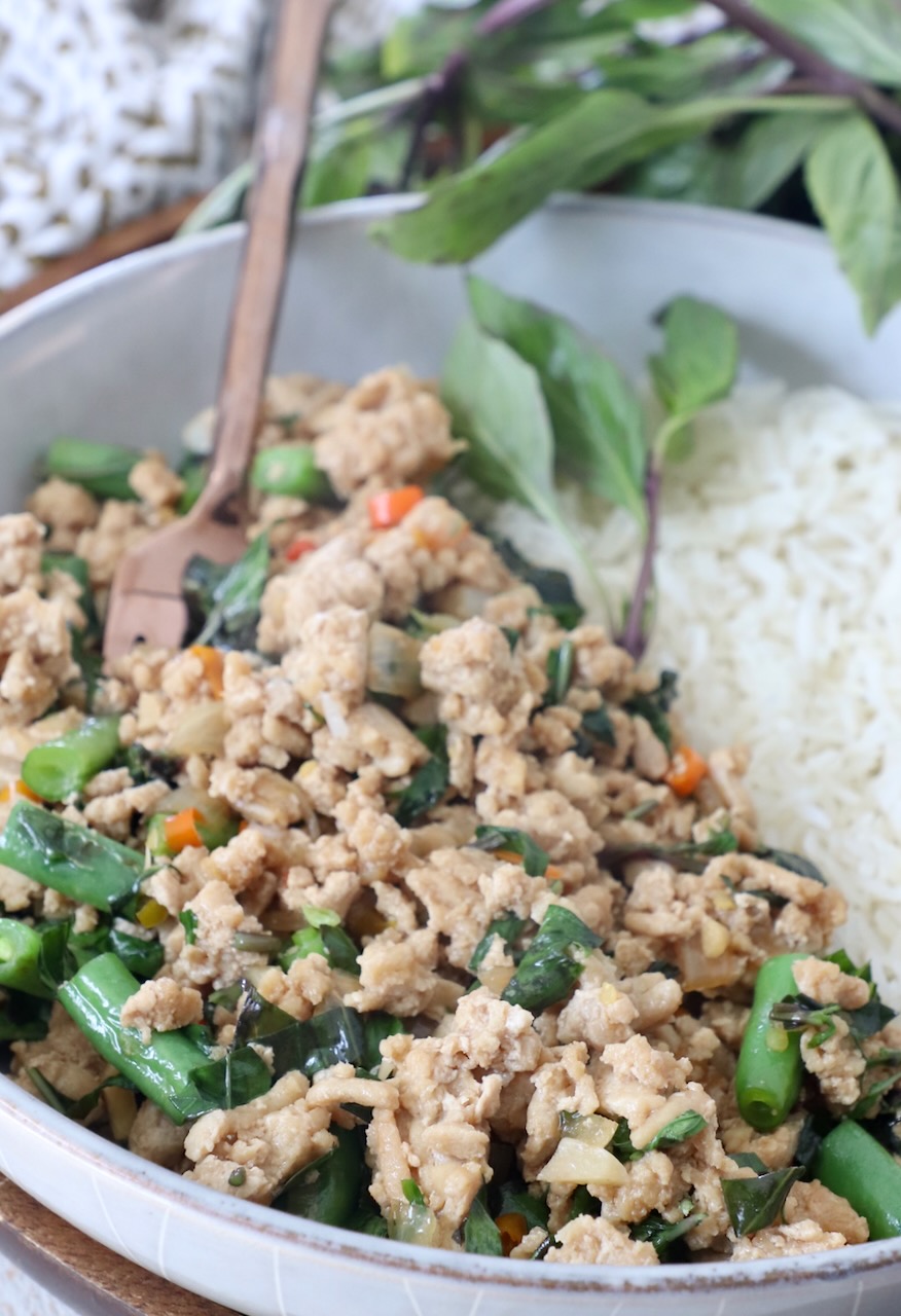cooked Thai basil chicken in bowl with white rice