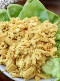coronation chicken on plate with leaves of lettuce