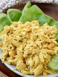 curry chicken salad on lettuce leaves on plate