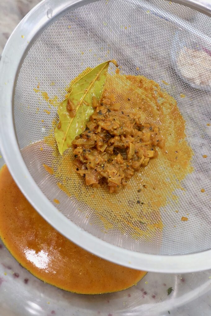 curry sauce pushed through a fine mesh strainer