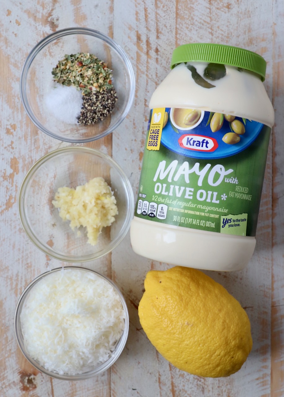 ingredients for garlic parmesan sauce on white wood board