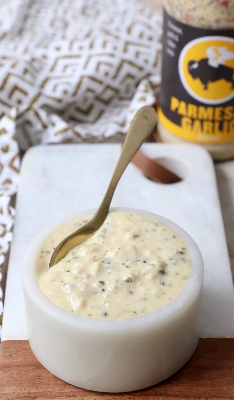 garlic parmesan sauce in small bowl with spoon