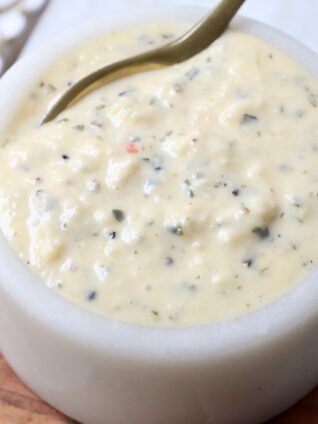 garlic parmesan sauce in small bowl with spoon