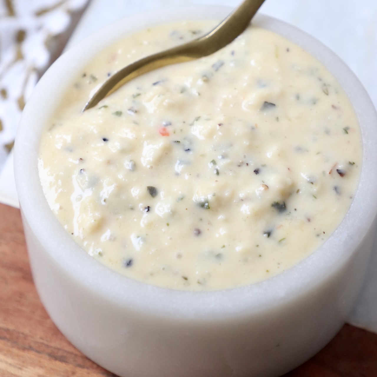 garlic parmesan sauce in small bowl with spoon