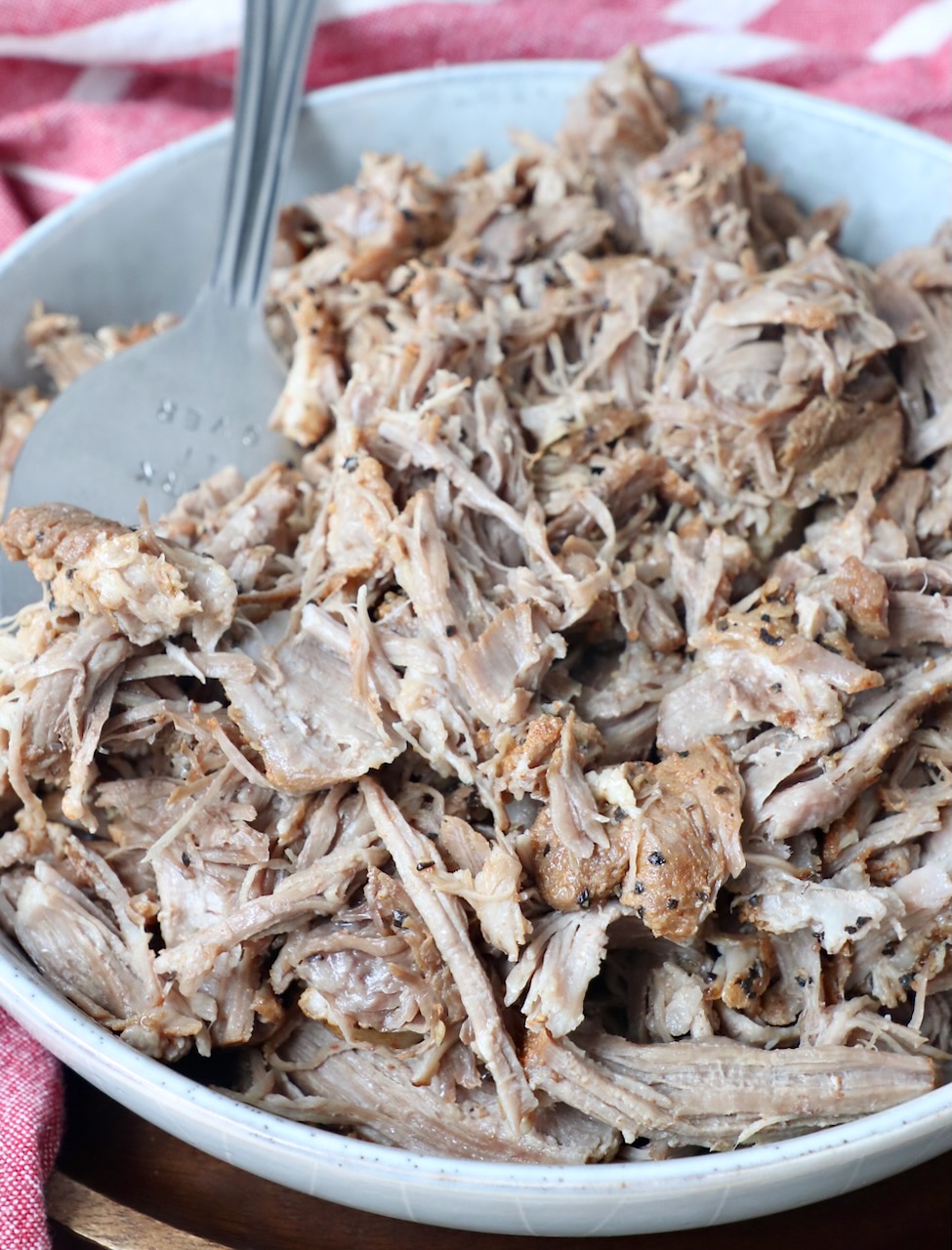 pulled pork in a bowl with large serving fork
