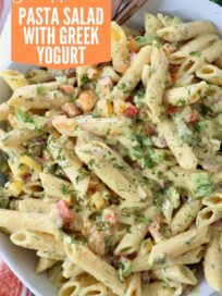 prepared pasta salad in creamy curry sauce in bowl with forks