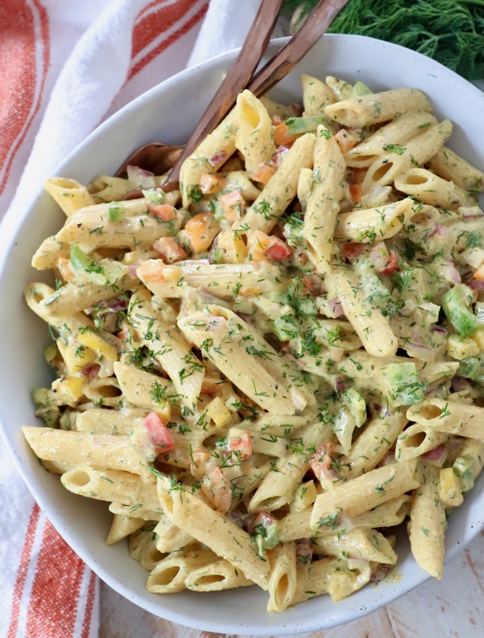 creamy curry pasta salad in bowl with forks