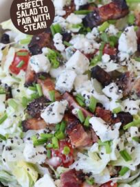 chopped salad in bowl topped with chopped bacon and blue cheese crumbles