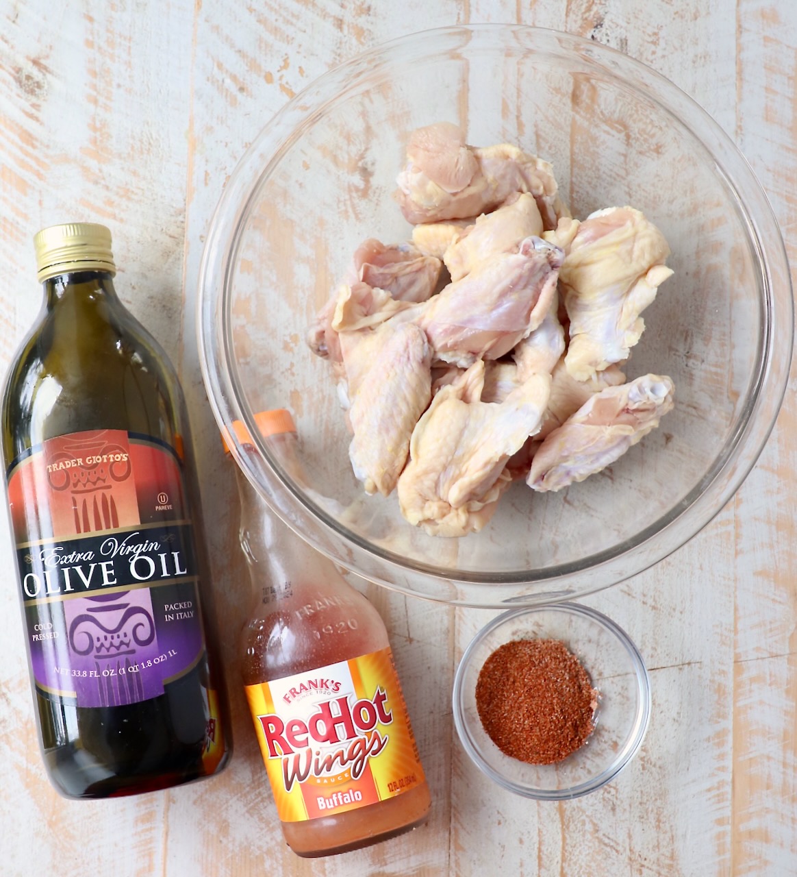 ingredients for grilled chicken wings on white wood board