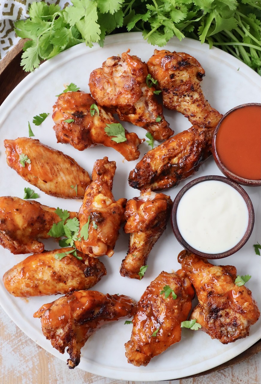 grilled chicken wings tossed with buffalo sauce on plate