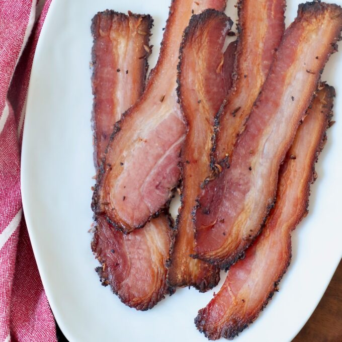 cooked slices of bacon on white plate