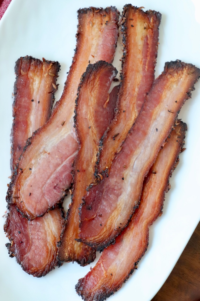 slices of cooked bacon on white plate