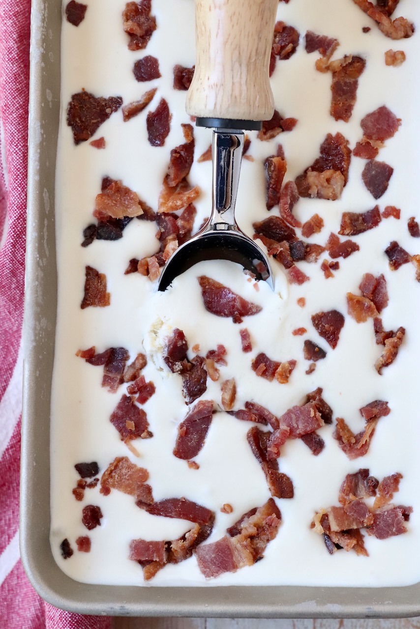maple bacon ice cream in metal container with ice cream scoop