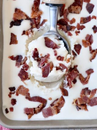 maple bacon ice cream in metal container with ice cream scoop