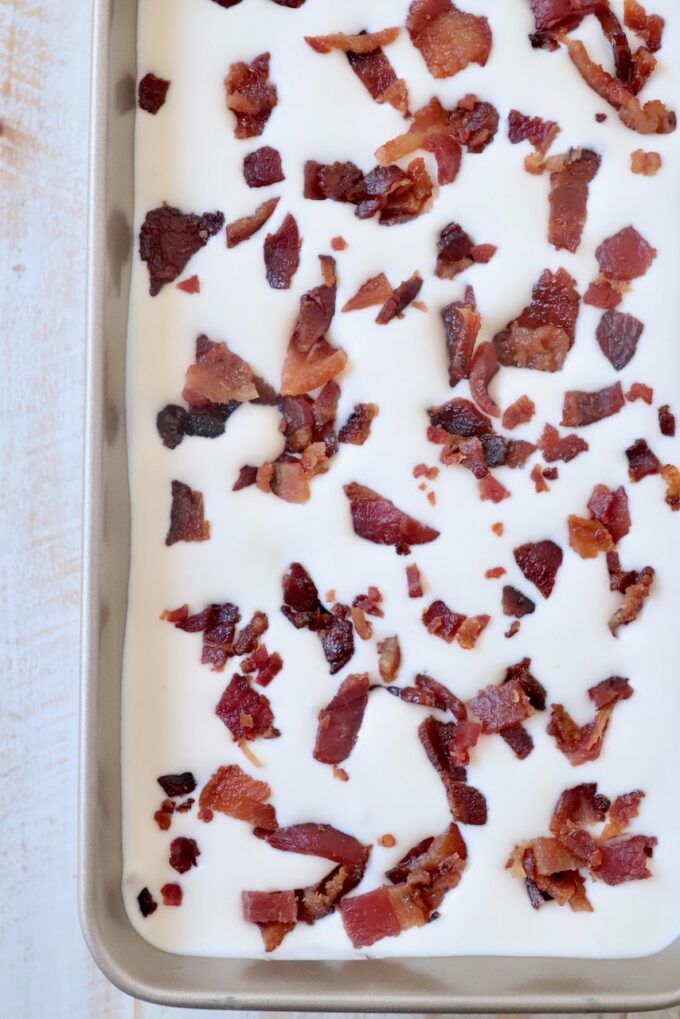 maple bacon ice cream topped with chopped bacon in metal container