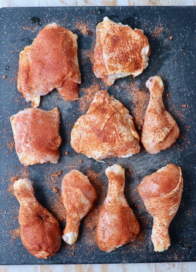 seasoned bone-in chicken pieces on cutting board
