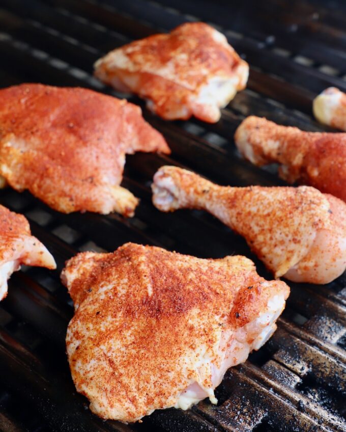 seasoned pieces of chicken on grill