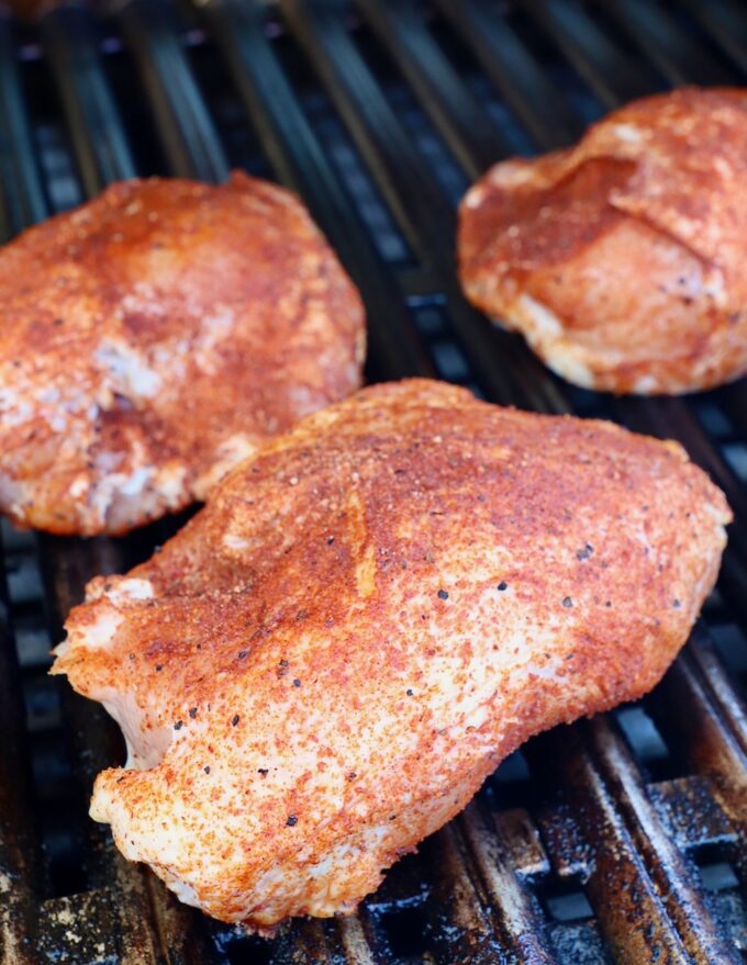 seasoned chicken breasts on grill