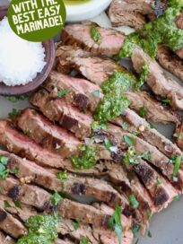 sliced skirt steak on plate topped with chimichurri sauce