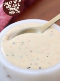 white bbq sauce in small white bowl with spoon