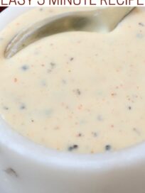 white bbq sauce in small white bowl with spoon