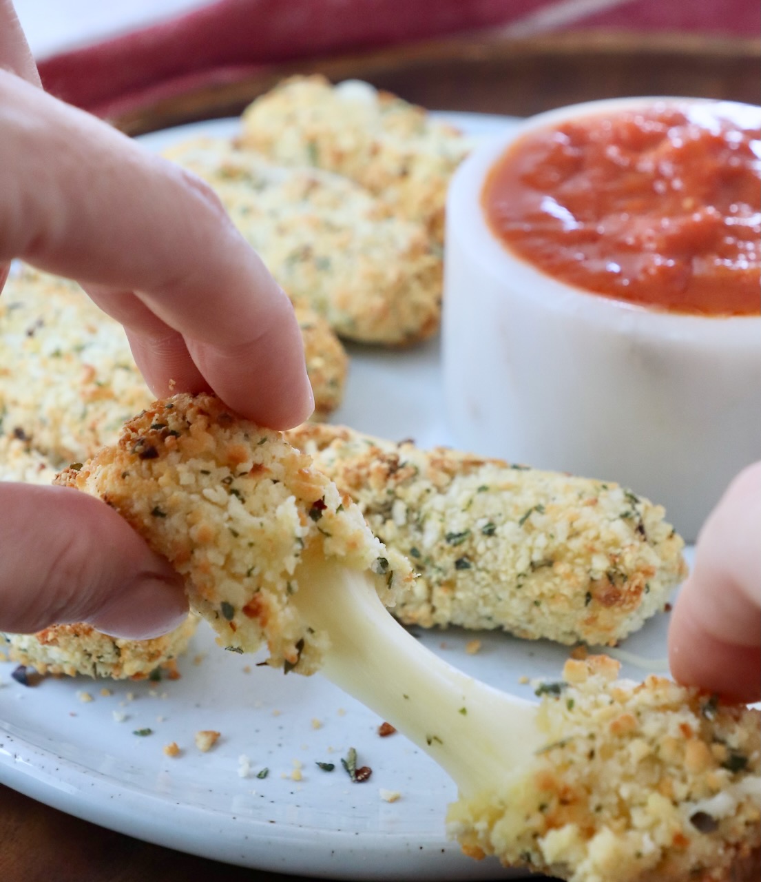 mozzarella stick being pulled in half by hands