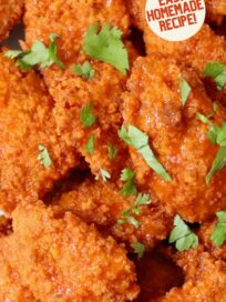 boneless chicken wings tossed with buffalo sauce on plate