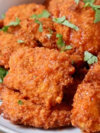 boneless wings tossed with buffalo sauce on plate