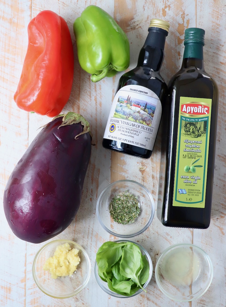 ingredients for eggplant salad on white wood board