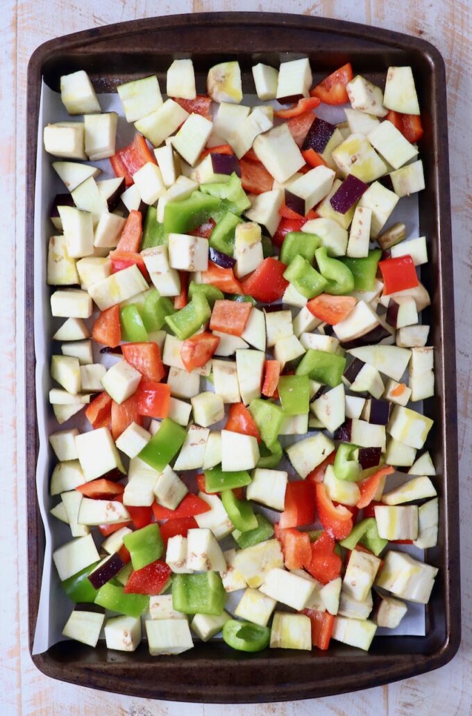 diced eggplant and bell peppers on baking sheet