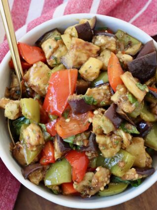 marinated eggplant salad in bowl with spoon
