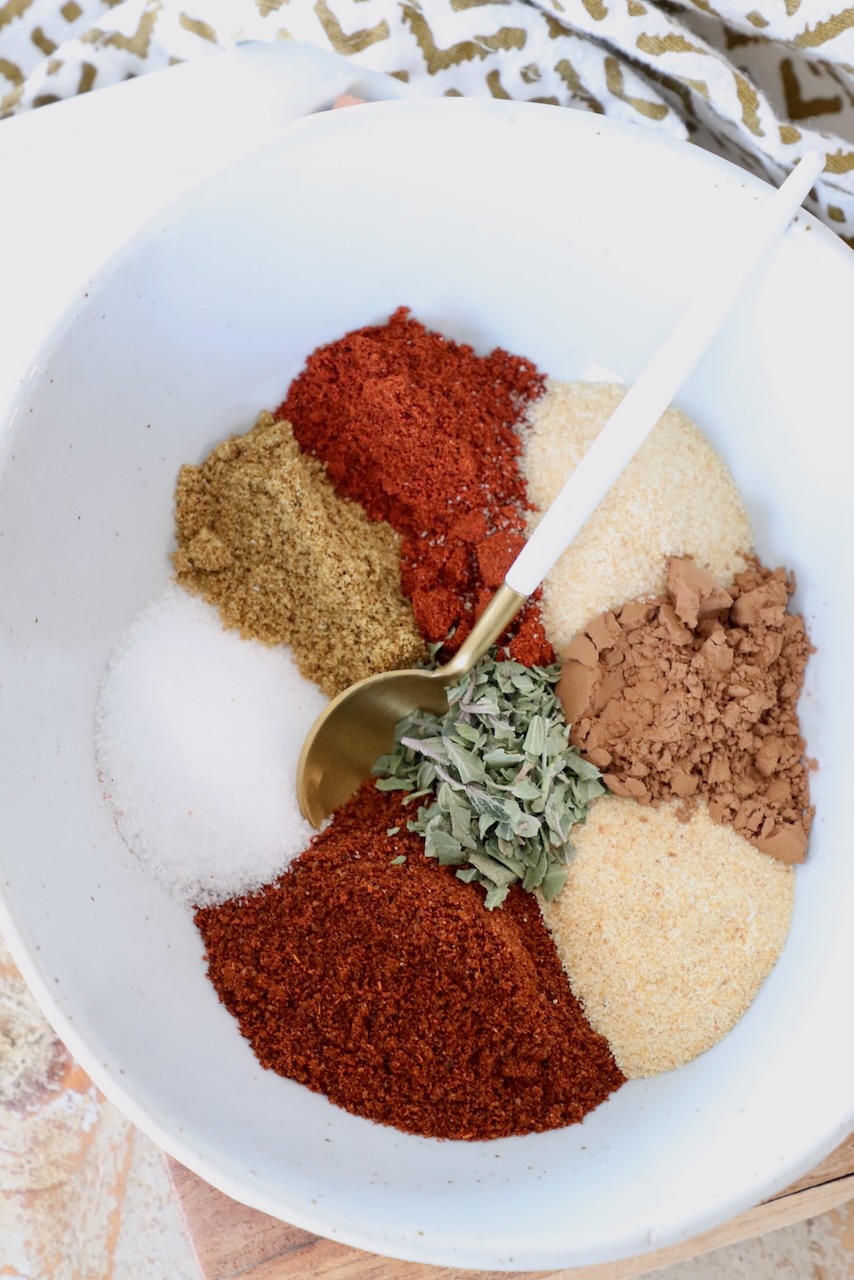 spices separated in a bowl with a spoon