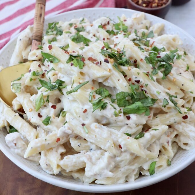 Gourmet style garlic parmesan chicken pasta served in a white bowl
