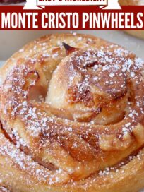 monte cristo rolls on a plate topped with powdered sugar
