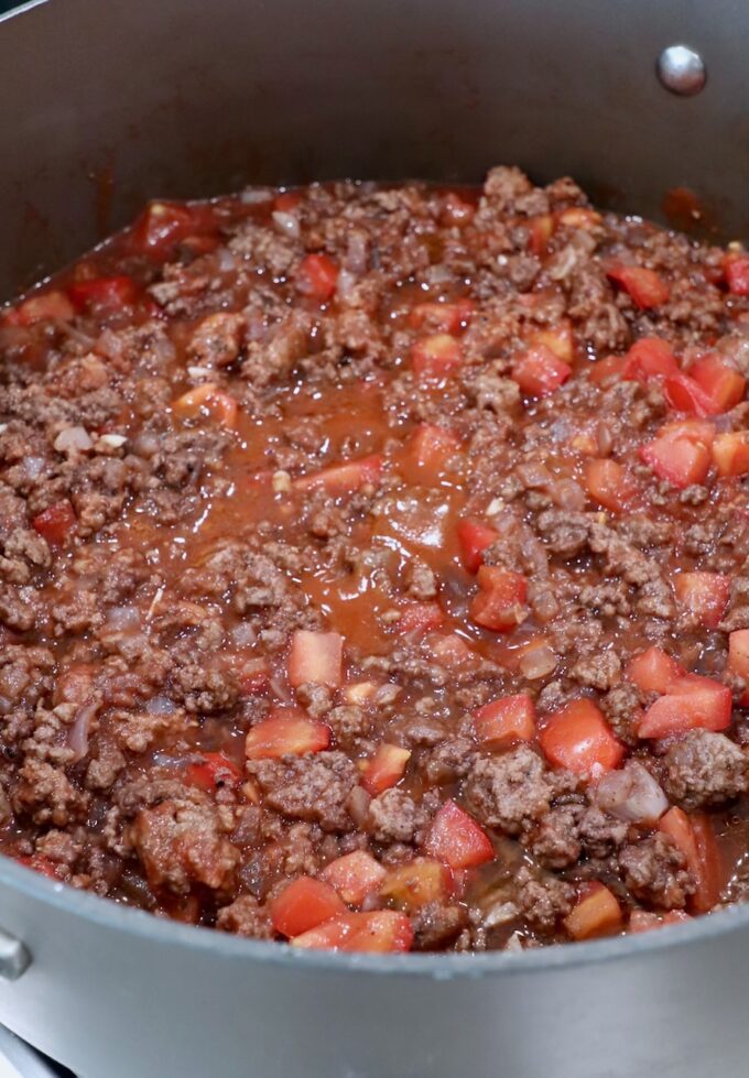cooked ground beef tomato sauce in large skillet
