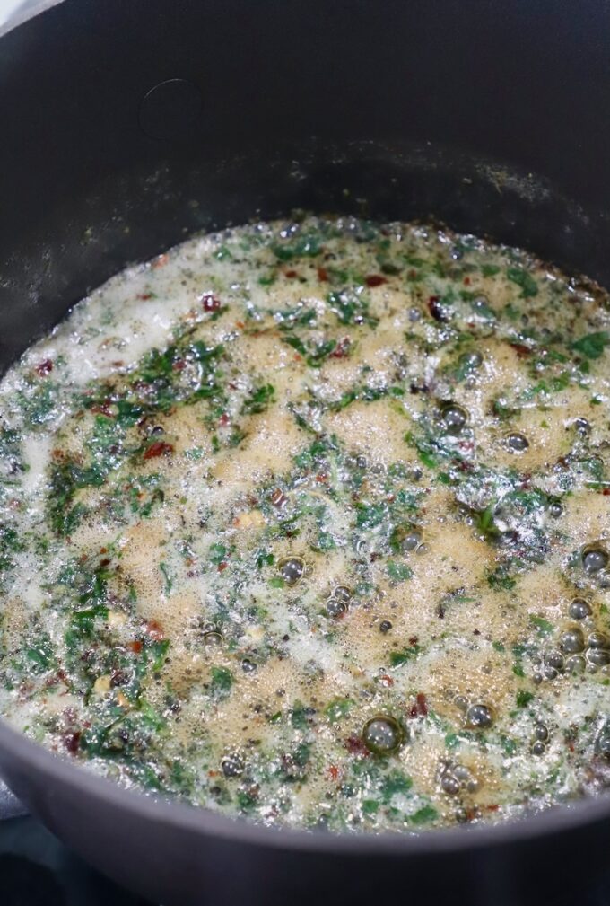 melted butter with herbs in saucepan